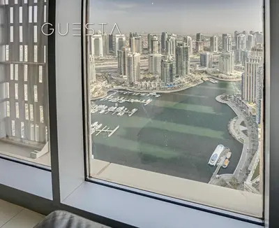 a view of the city from a hotel room window at Cayan Tower, Dubai Marina in Dubai