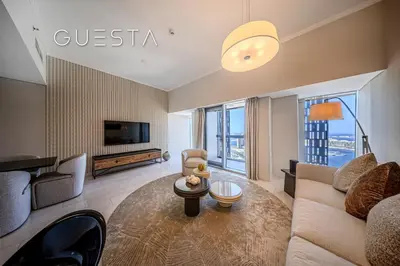 a living room with a couch and a tv at Cayan Tower, Dubai Marina in Dubai