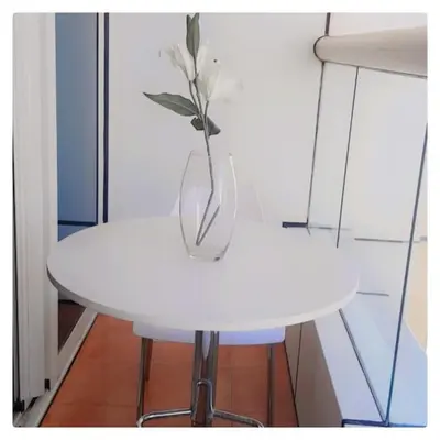 a white table with a vase on top of it at Luxury Kings Palace Private Room with Shared Kitchen Next To Barasti Beach in Dubai