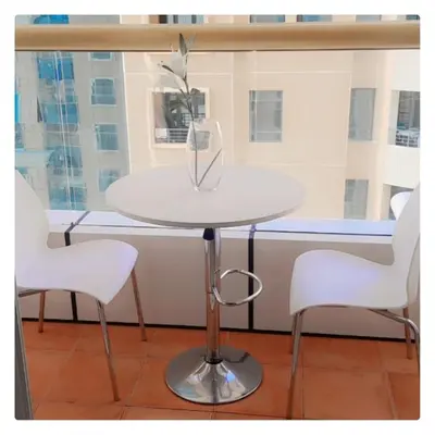 a white table with two chairs and a vase on it at Luxury Kings Palace Private Room with Shared Kitchen Next To Barasti Beach in Dubai