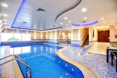 a swimming pool in a hotel room with a hotel at Luxury Kings Palace Private Room with Shared Kitchen Next To Barasti Beach in Dubai