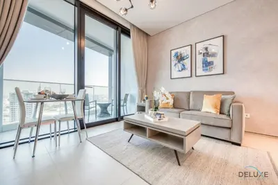 a living room with a couch and a table at Posh 1BR at The Address Residences in JBR by Deluxe Holiday Homes in Dubai