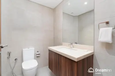 a white bathroom with a sink and a toilet at Dream Inn Apartments - Mina by Azizi in Dubai