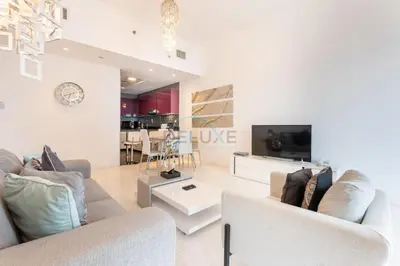 a living room with two couches and a tv at Sea Views 1BR in the Heart of Dubai Marina by Deluxe Holiday Homes in Dubai