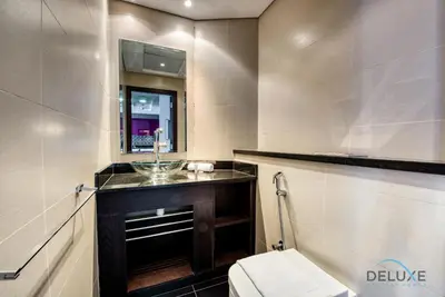 a bathroom with a toilet and a sink and a mirror at Sea Views 1BR in the Heart of Dubai Marina by Deluxe Holiday Homes in Dubai
