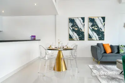 a living room with a table and a couch at Dream Inn - Damac Heights by Fendi in Dubai