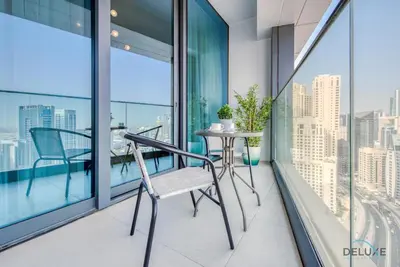 a balcony with a table and chair on a balcony at Captivating 1BR at The Address Residences in JBR by Deluxe Holiday Homes in Dubai