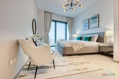 a bedroom with a bed and a desk and a chair at Captivating 1BR at The Address Residences in JBR by Deluxe Holiday Homes in Dubai