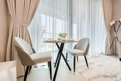 a dining room with a table and chairs in front of a window at Captivating 1BR at The Address Residences in JBR by Deluxe Holiday Homes in Dubai