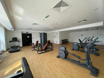 a gym with treadmills and exercise equipment in a room at Peaceful Oasis 3BR+kids, 7 min walk to Dubai Mall in Dubai