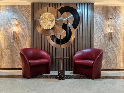 a lobby with two chairs and a chandelier at Elan Murjan Rimal Suites, Sea in 3 min walk! 6 Bedrooms & Hall, Massive Layout in Dubai