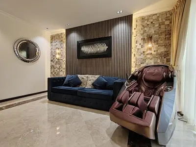 a living room with a blue couch and a suitcase at Elan Murjan Rimal Suites, Sea in 3 min walk! 6 Bedrooms & Hall, Massive Layout in Dubai