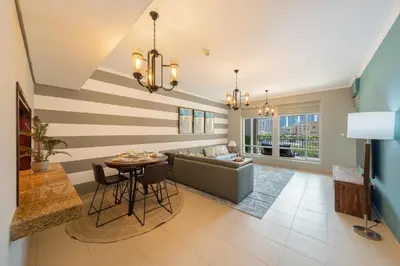 a living room with a couch and a table at One Bedroom in Burj Views by Radiance Vacation Stays in Dubai
