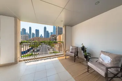 a room with a balcony with a view of the city at One Bedroom in Burj Views by Radiance Vacation Stays in Dubai