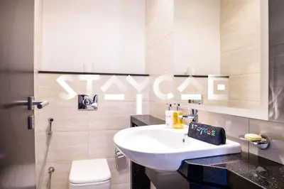 a bathroom with a sink and a toilet at Staycae Holiday Homes - Celestia in Dubai