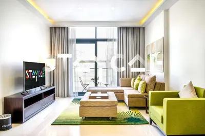 a living room with a couch and a tv at Staycae Holiday Homes - Celestia in Dubai