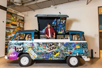 a man standing in the back of a food truck at Rove City Walk in Dubai