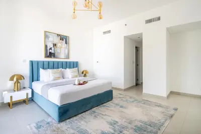 a bedroom with a blue and white bed and a rug at Frank Porter - The Pulse Residences in Dubai