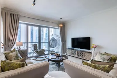 a living room with white furniture and a large window at The Smart Concierge - 8 BLVD Walk in Dubai