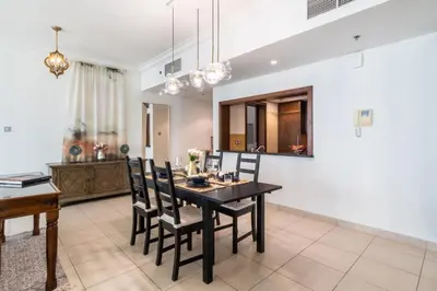 a dining room with a black table and chairs at The Smart Concierge - 8 BLVD Walk in Dubai