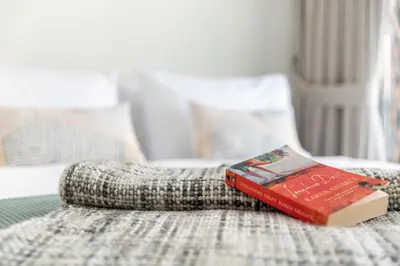 a book sitting on top of a bed at The Smart Concierge - 8 BLVD Walk in Dubai