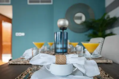 a table with a plate of food and drinks on it at Burj Residence by Radiance Vacation Stays in Dubai