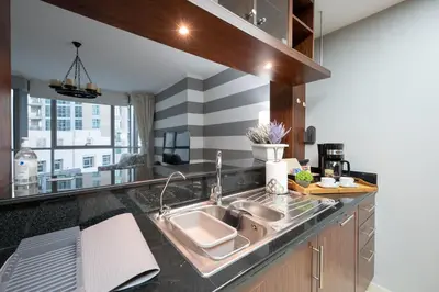 a kitchen with a sink and a counter top at Burj Residence by Radiance Vacation Stays in Dubai