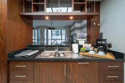 a kitchen with a sink and a counter top at Burj Residence by Radiance Vacation Stays in Dubai