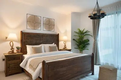 a bedroom with a large bed and a window at Burj Residence by Radiance Vacation Stays in Dubai