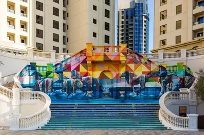 a mural on the side of a building with stairs at VIP Castles JBR Rimal 3 Suite 1 Bedroom in Dubai