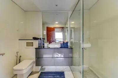 a bathroom with a shower and a toilet and a sink at VIP Castles JBR Rimal 3 Suite 1 Bedroom in Dubai