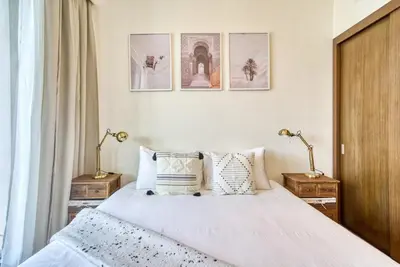 a bedroom with a bed with pillows and pictures on the wall at Incredible Views From This Classy Apt With Terrace in Dubai