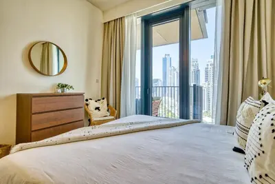 a bedroom with a large bed and a large window at Incredible Views From This Classy Apt With Terrace in Dubai