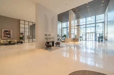 a lobby of a building with a sign that reads avid hers at Incredible Views From This Classy Apt With Terrace in Dubai