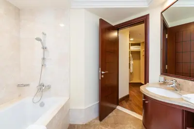 a bathroom with a tub and a sink at Royal Club By RVHR, Grandeur Residence Crescent Palm Jumeirah in Dubai