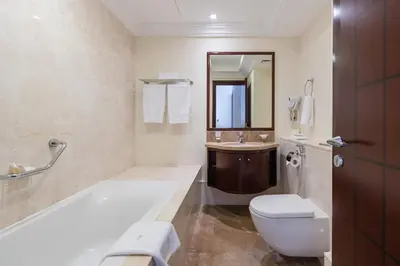 a bathroom with a toilet and a sink at Royal Club By RVHR, Grandeur Residence Crescent Palm Jumeirah in Dubai