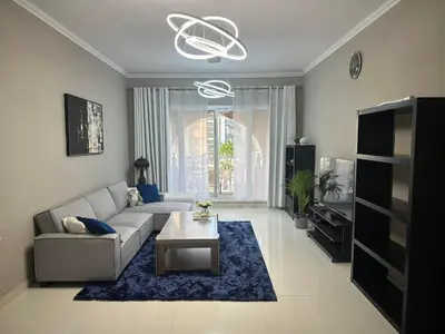 a living room with a couch and a table at Huge Entire apartment for Couples ,families & Groups -up to 5 Guests- with free pool, steam & Sauna ,JVC,Dubai in Dubai