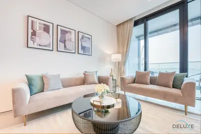 a living room with a couch and a table at Pristine 2BR with Assistants Room at The Address Residences in JBR by Deluxe Holiday Homes in Dubai