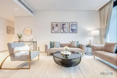 a living room with a couch and a table at Pristine 2BR with Assistants Room at The Address Residences in JBR by Deluxe Holiday Homes in Dubai