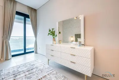 a bathroom with a white dresser and a mirror at Pristine 2BR with Assistants Room at The Address Residences in JBR by Deluxe Holiday Homes in Dubai