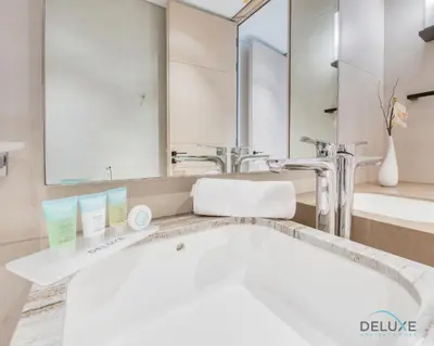 a bathroom with a white sink and a mirror at Pristine 2BR with Assistants Room at The Address Residences in JBR by Deluxe Holiday Homes in Dubai