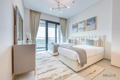 two beds in a hotel room with windows at Pristine 2BR with Assistants Room at The Address Residences in JBR by Deluxe Holiday Homes in Dubai