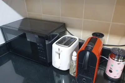 a kitchen counter with a microwave and a toaster oven at Beautiful apartment with amazing sea views in Dubai