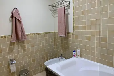 a bathroom with a tub and a sink at Beautiful apartment with amazing sea views in Dubai