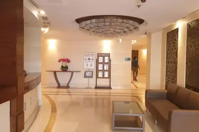 a lobby with a couch and a table and a chandelier at Beautiful apartment with amazing sea views in Dubai