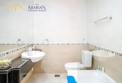 a bathroom with a toilet and a sink at New Arabian Trident Waterfront 3 BR plus maid in Dubai