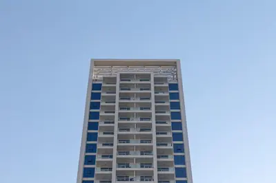 a tall building with a blue sky in the background at Frank Porter - Studio One in Dubai
