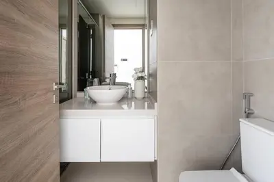 a bathroom with a white sink and a mirror at Frank Porter - Studio One in Dubai