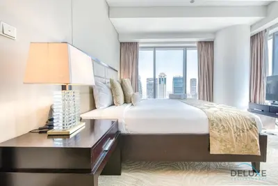 a bedroom with a large bed and a large window at Pristine 1BR at The Address Residences Dubai Marina by Deluxe Holiday Homes in Dubai