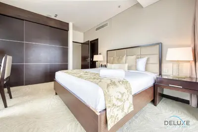 a bedroom with a large bed and a desk at Pristine 1BR at The Address Residences Dubai Marina by Deluxe Holiday Homes in Dubai